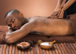 Young African Man Getting Massage In Spa